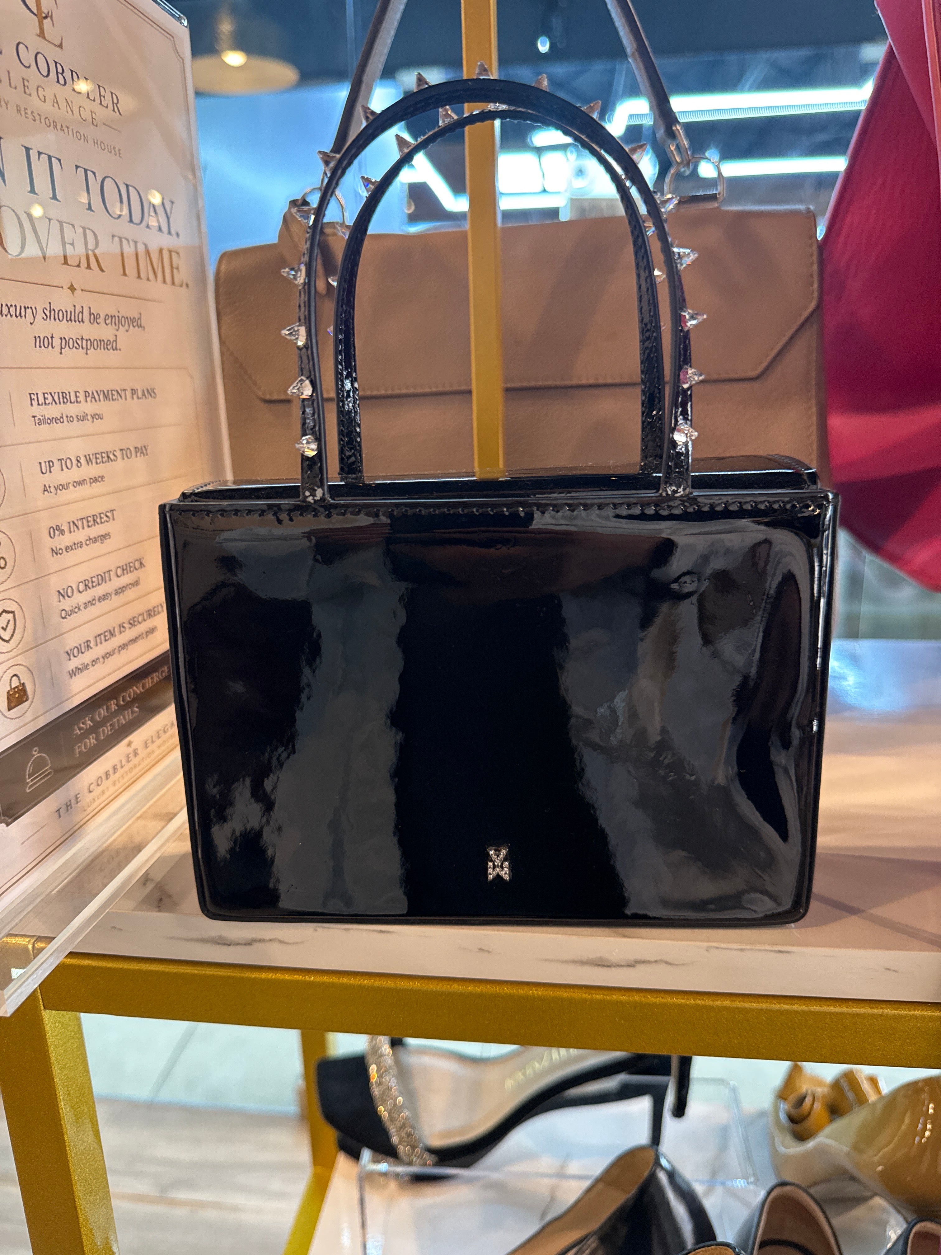 Amina Muaddi black patent leather
